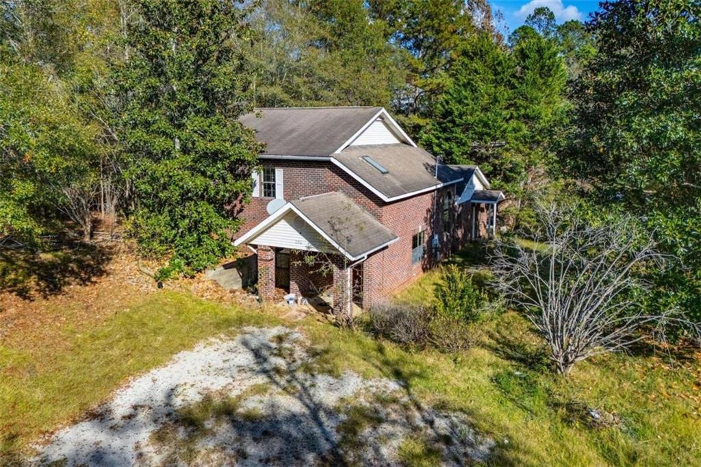 an aerial view of a house with a yard