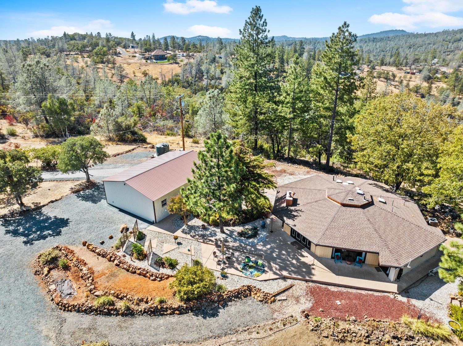 an aerial view of a house with a yard and lake view