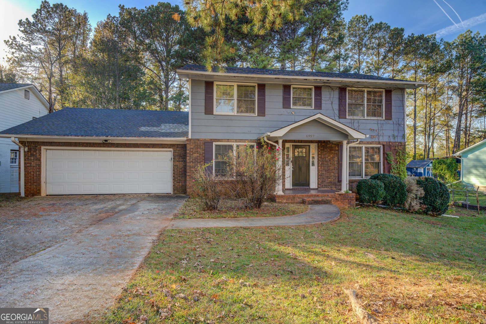 a front view of a house with yard patio and green space