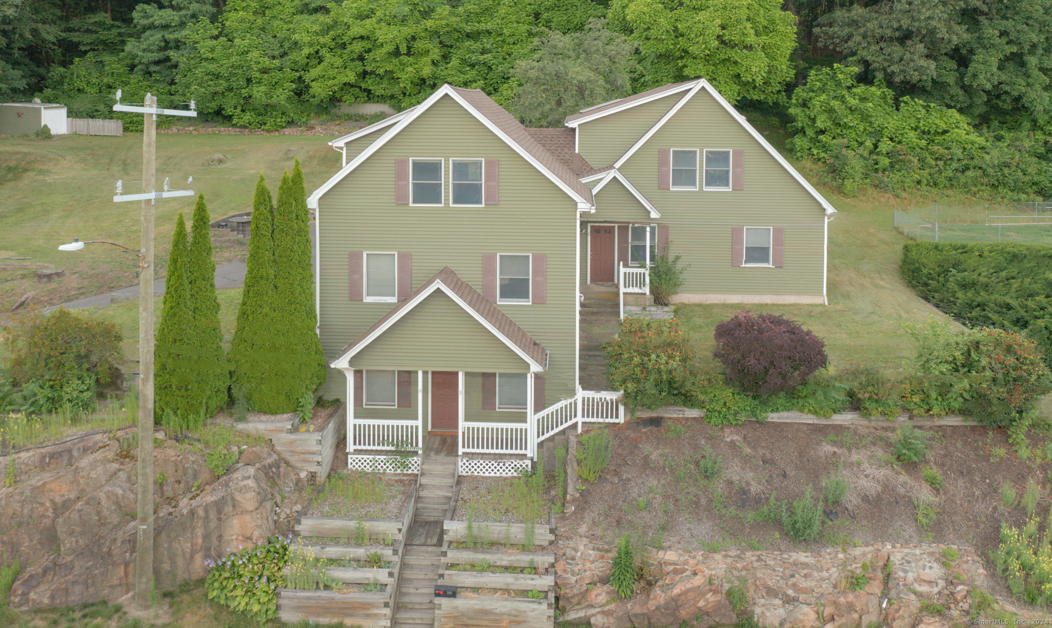 a front view of a house with garden