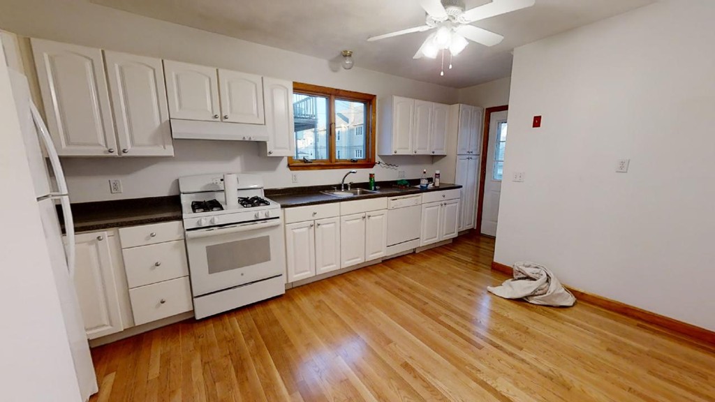 a kitchen with a sink window and cabinets