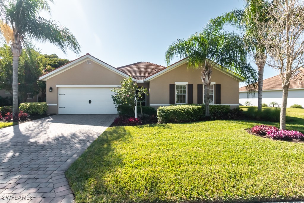 a front view of a house with a yard and garage