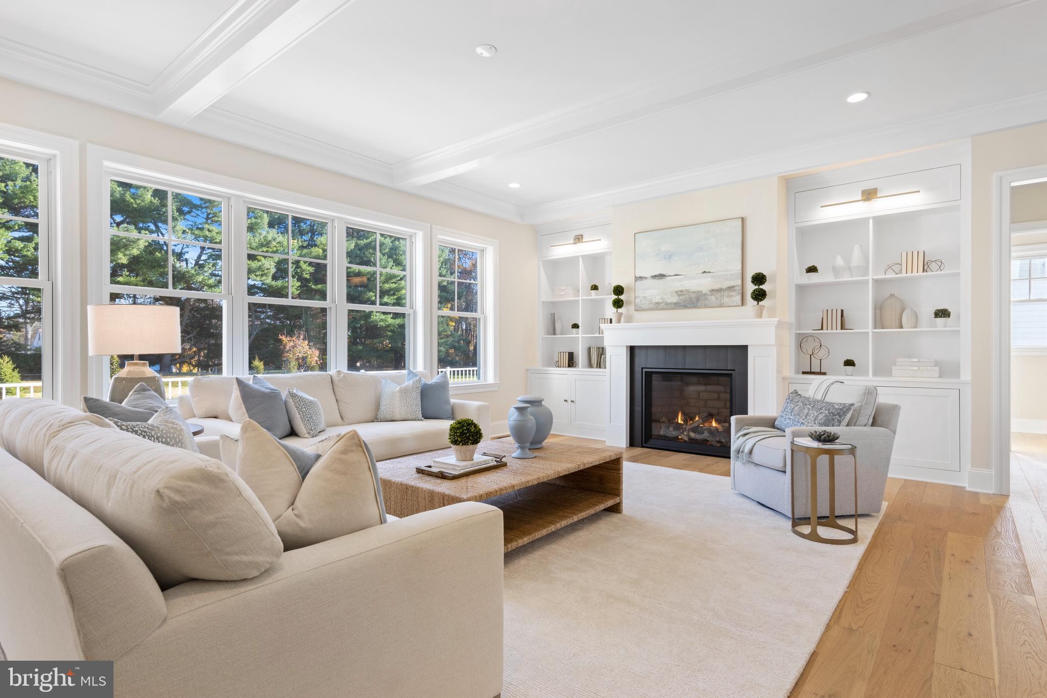 a living room with furniture a large window and a fireplace