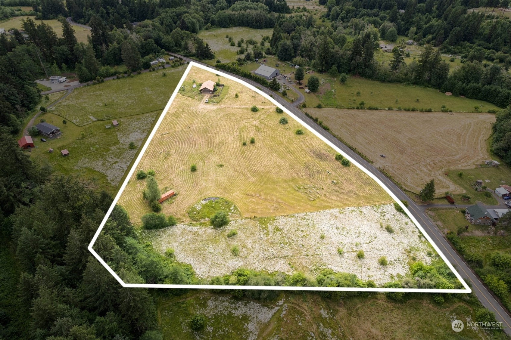 an aerial view of a house with a yard and pool