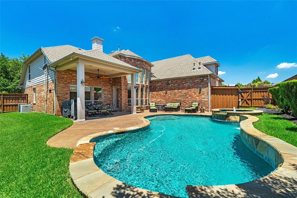 a view of a house with a backyard porch and sitting area