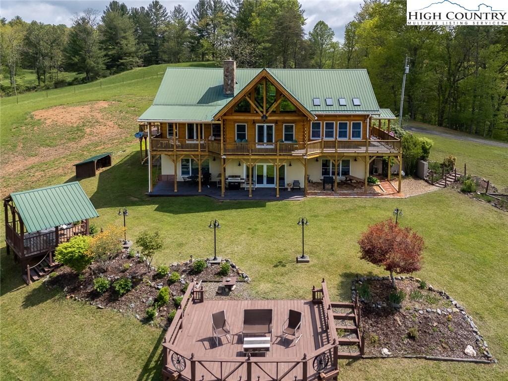 an aerial view of a house with swimming pool garden and patio