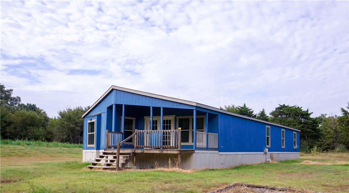 a view of a house with backyard porch and sitting area