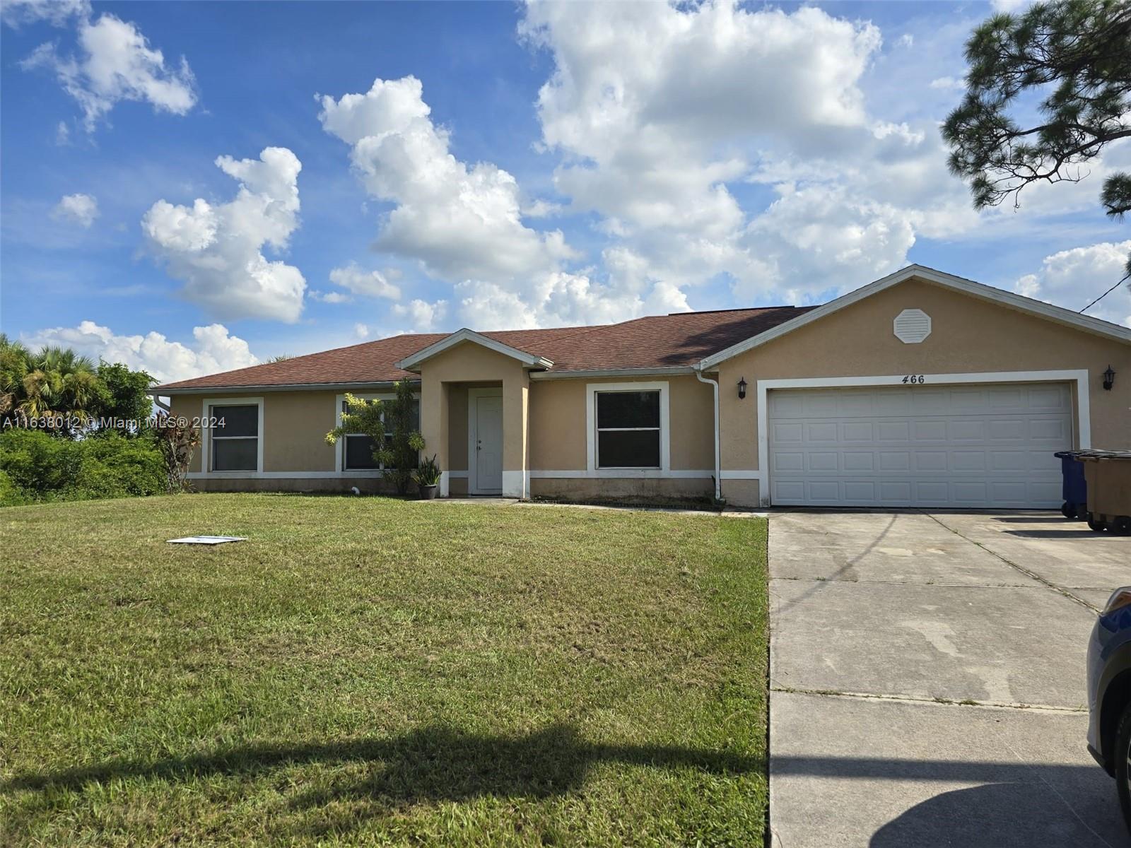 a front view of house with yard and green space