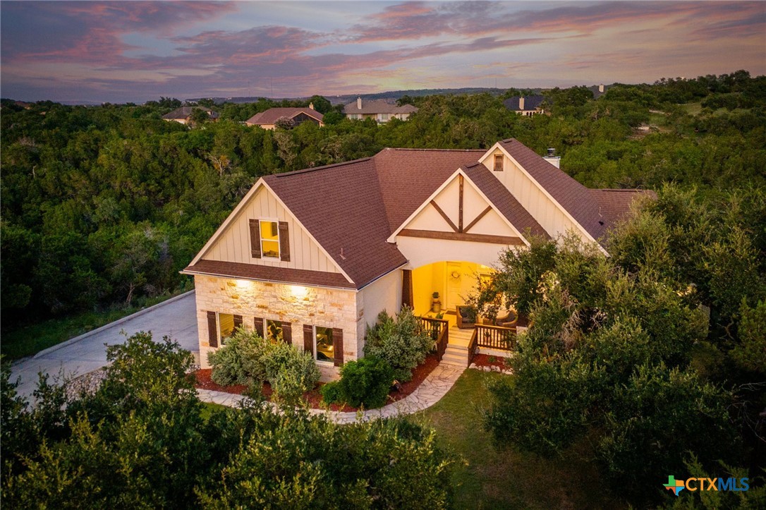 a aerial view of a house with a yard and lake view