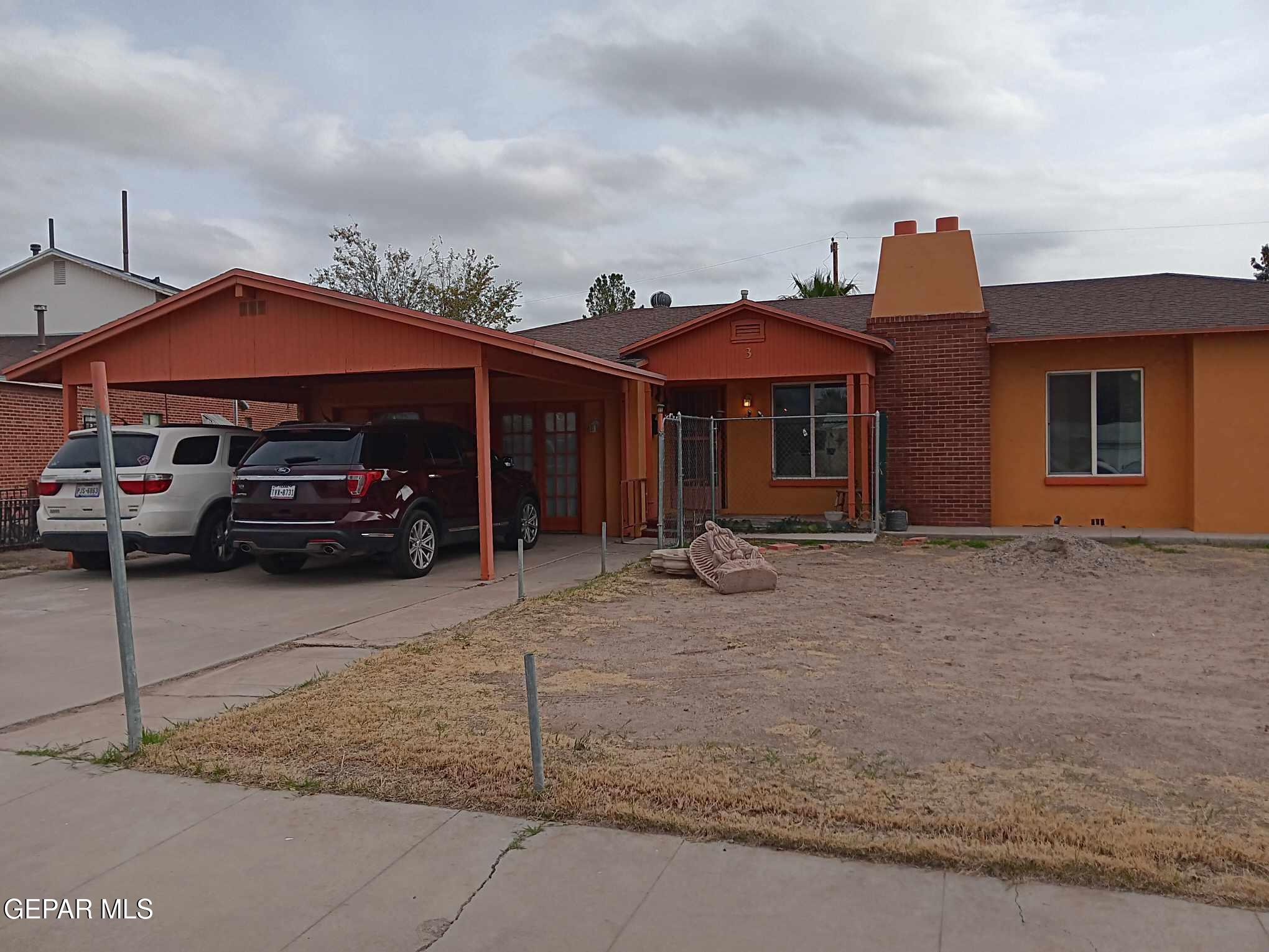 a front view of a house with parking space