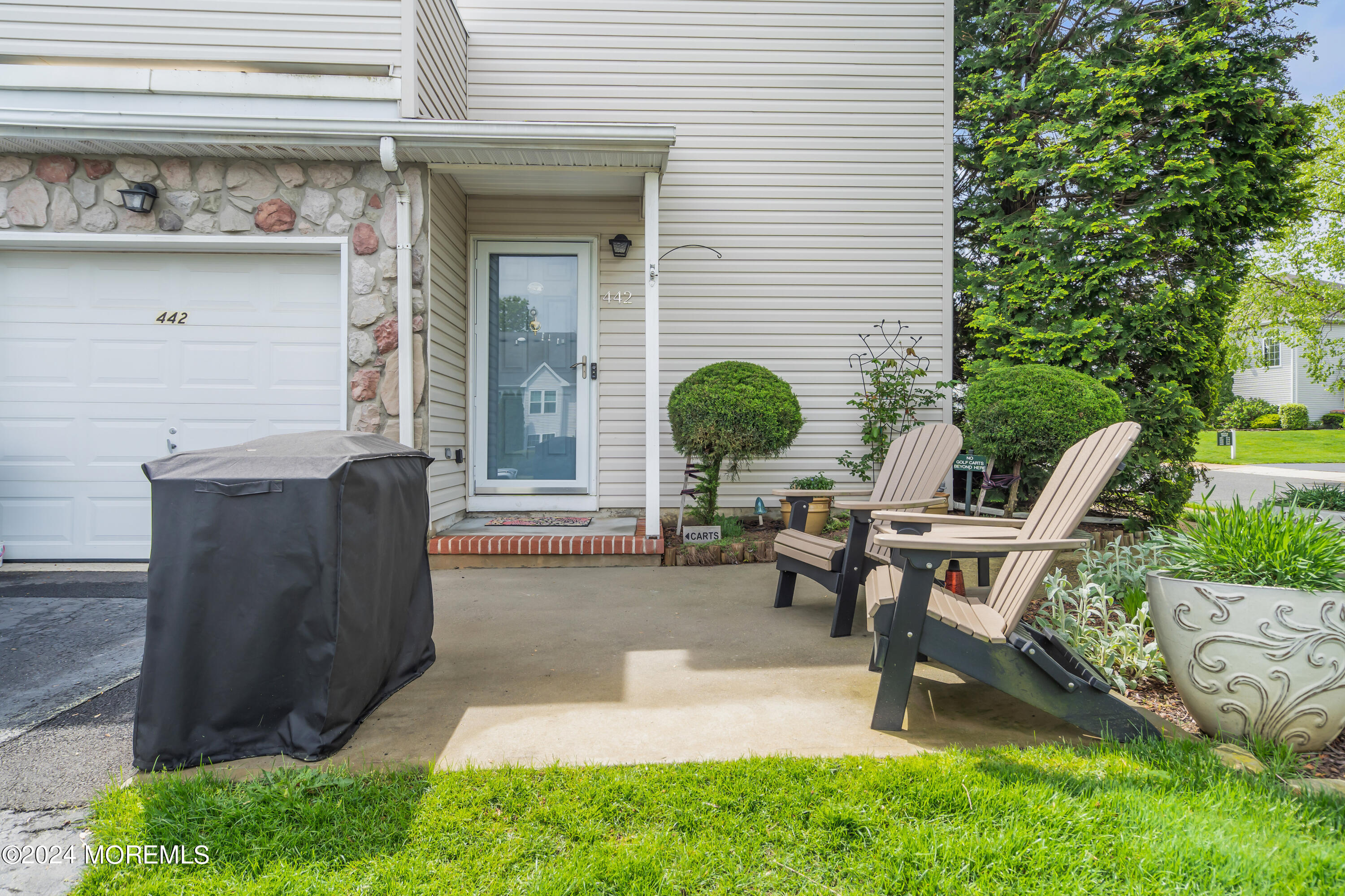 a view of a house with backyard and sitting area