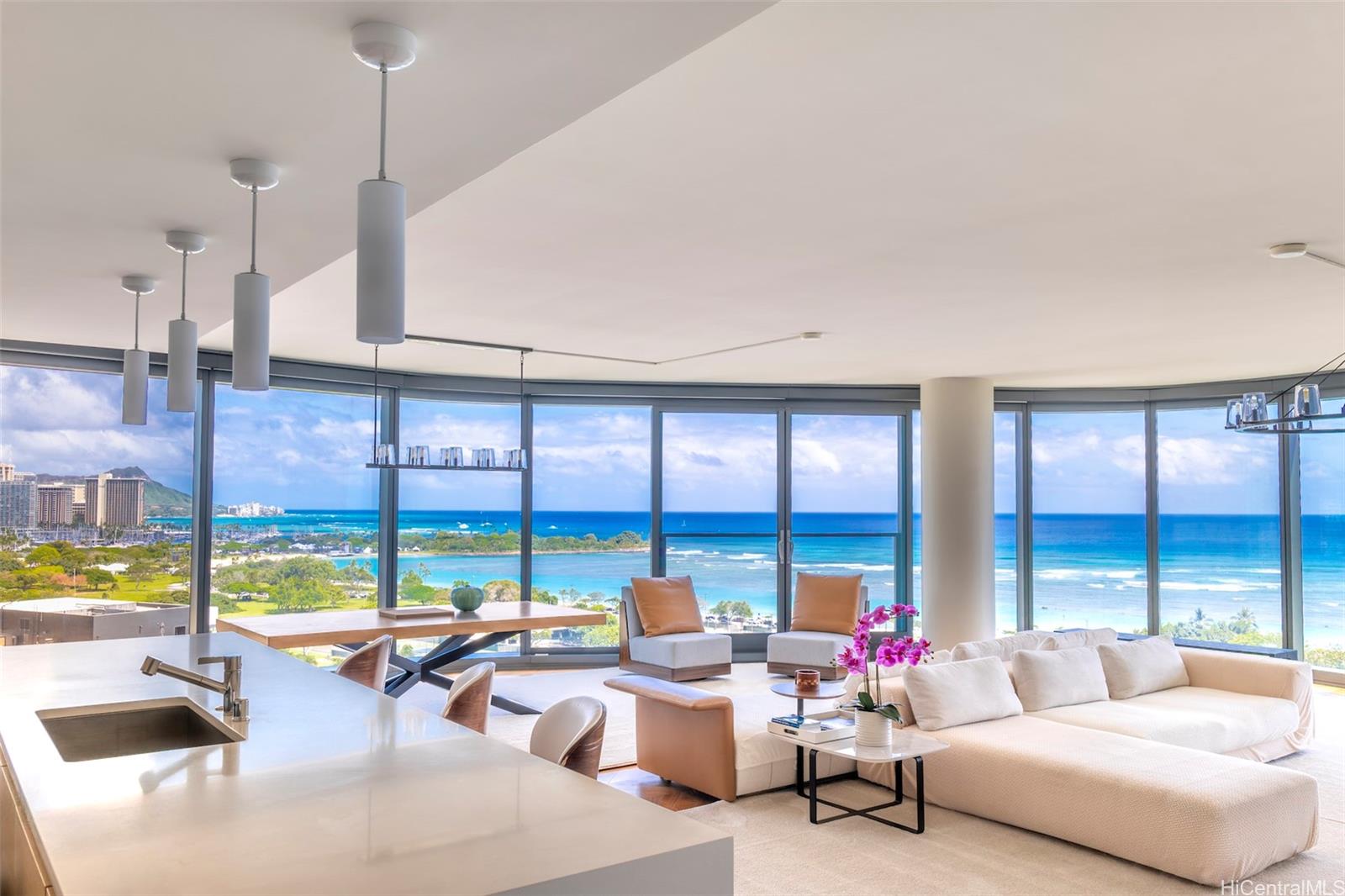 a living room with furniture and floor to ceiling windows