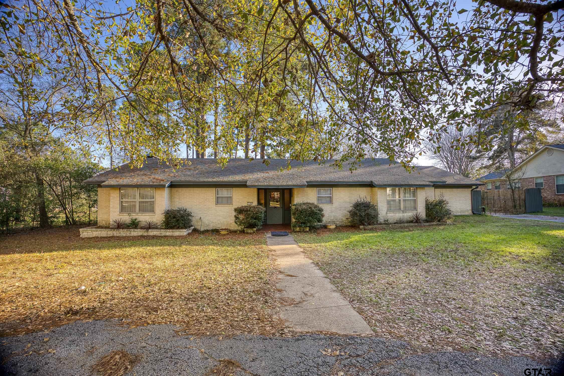 a house that has a tree in front of it