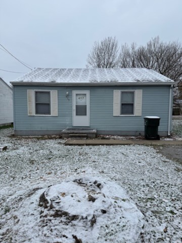 a house that has a tree in front of it