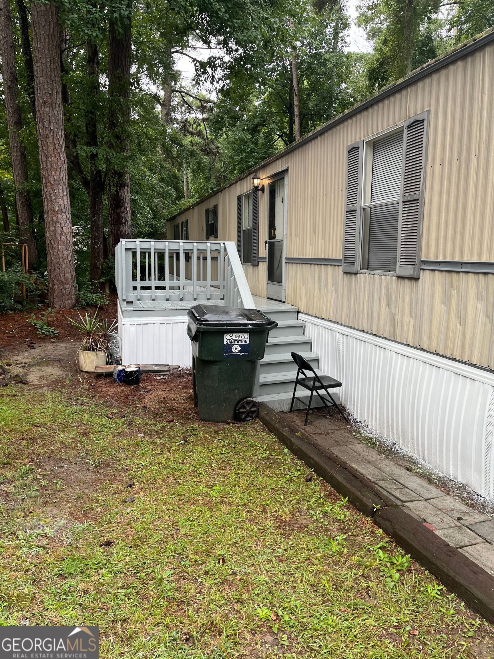 a view of a house with backyard and sitting area