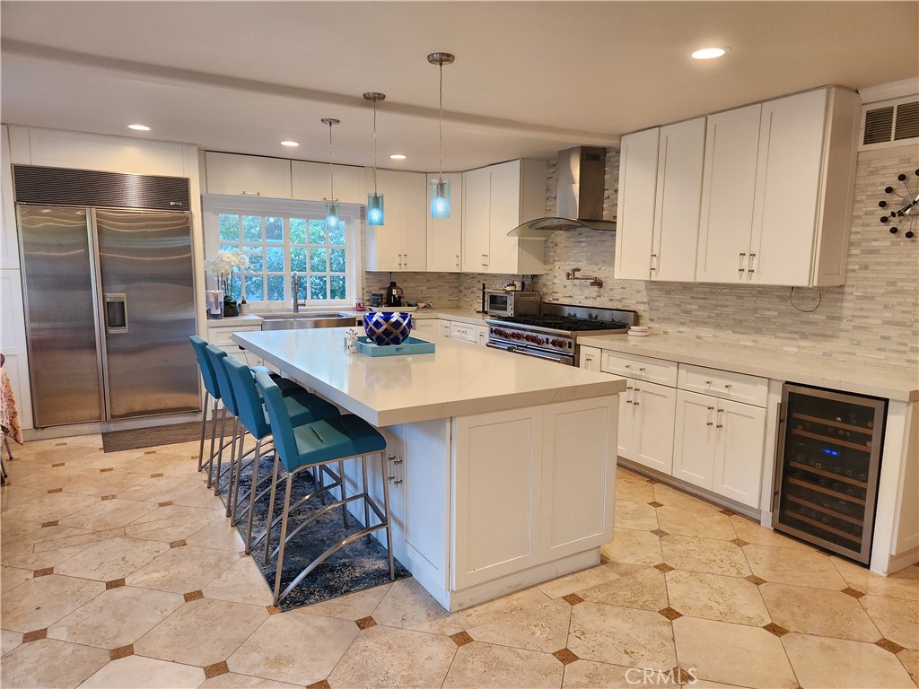 a kitchen with a sink a stove a microwave a counter top space and cabinets