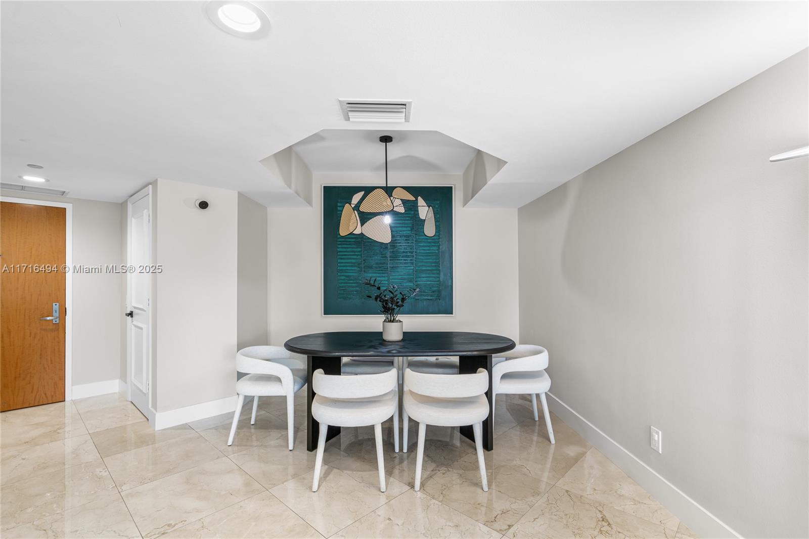 a dining room with a table and chairs