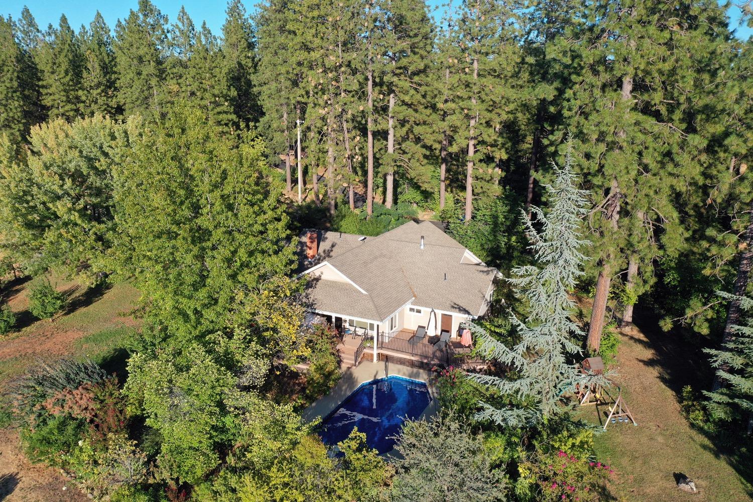 an aerial view of a house with yard and outdoor seating