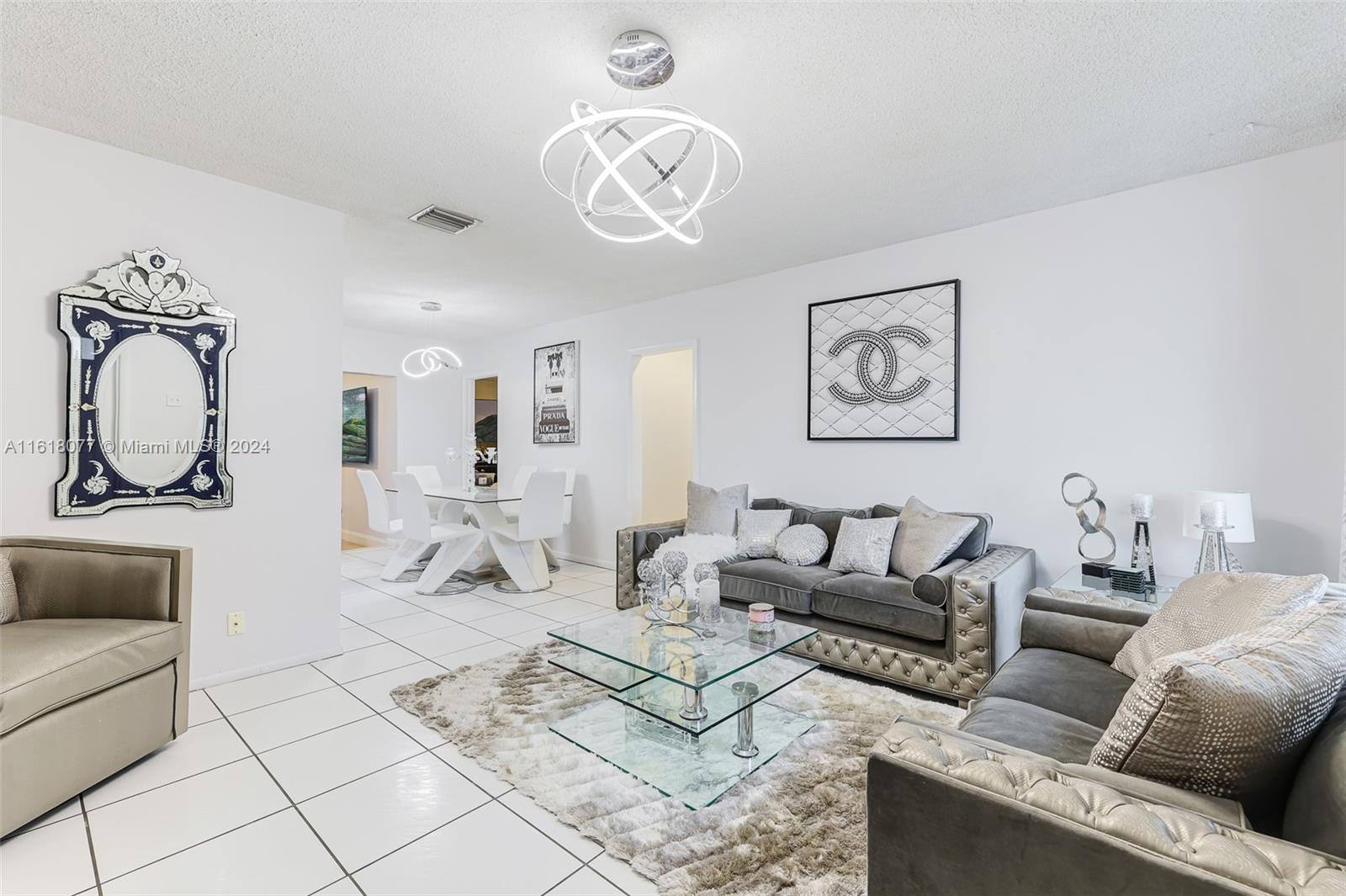 a living room with furniture a couch and a chandelier