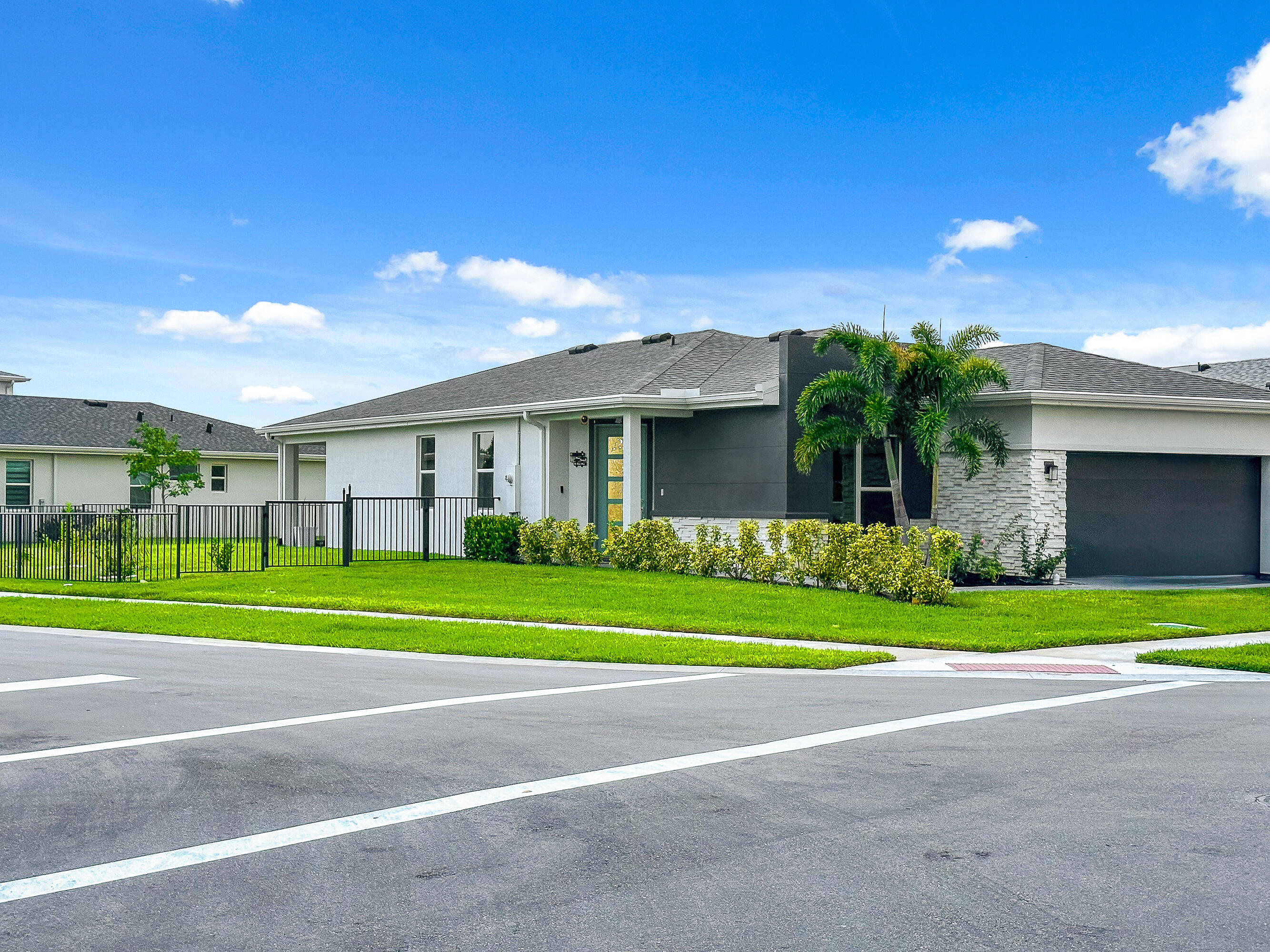 a front view of a house with a yard and a garage