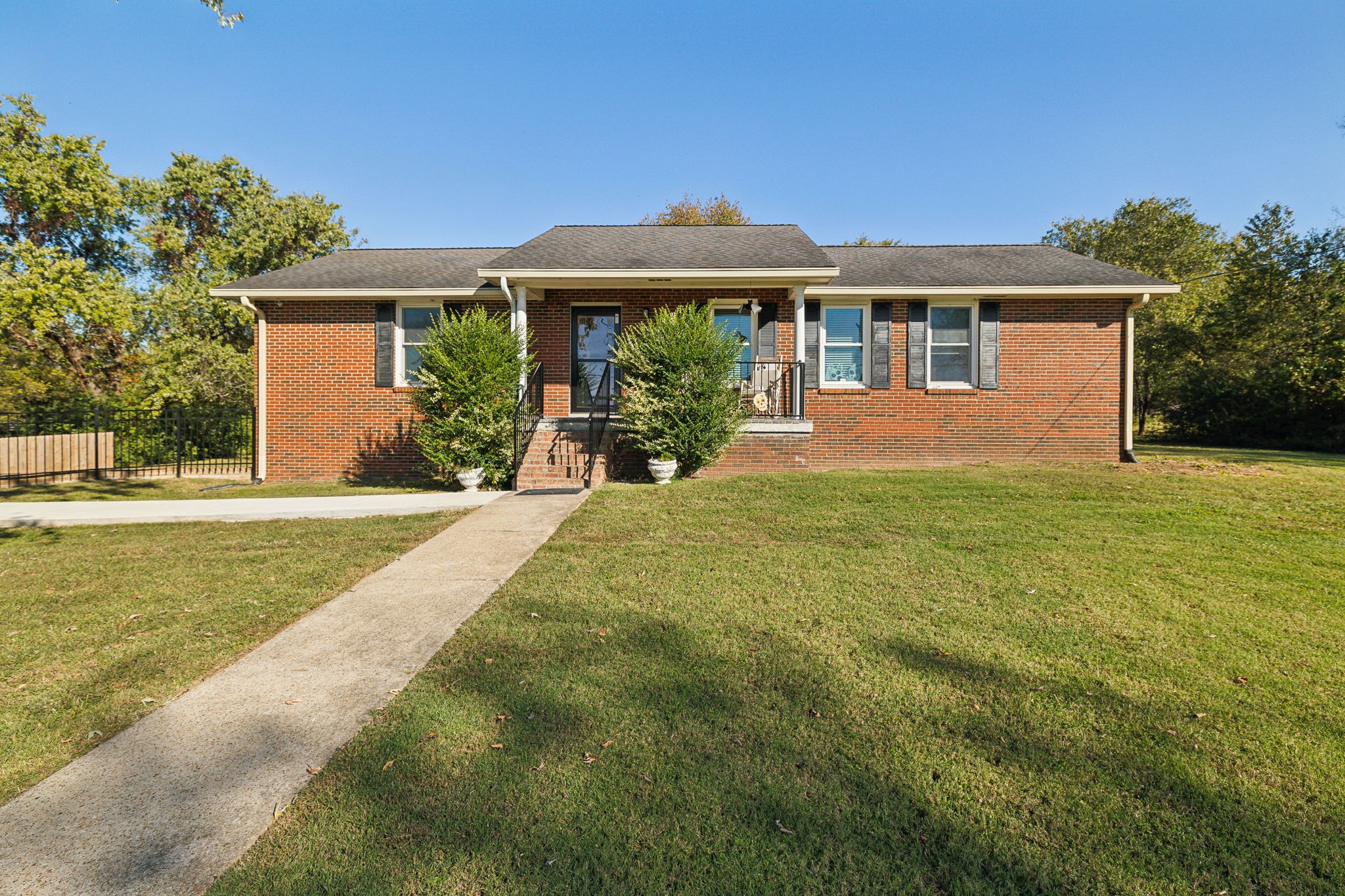 a front view of a house with a yard and porch