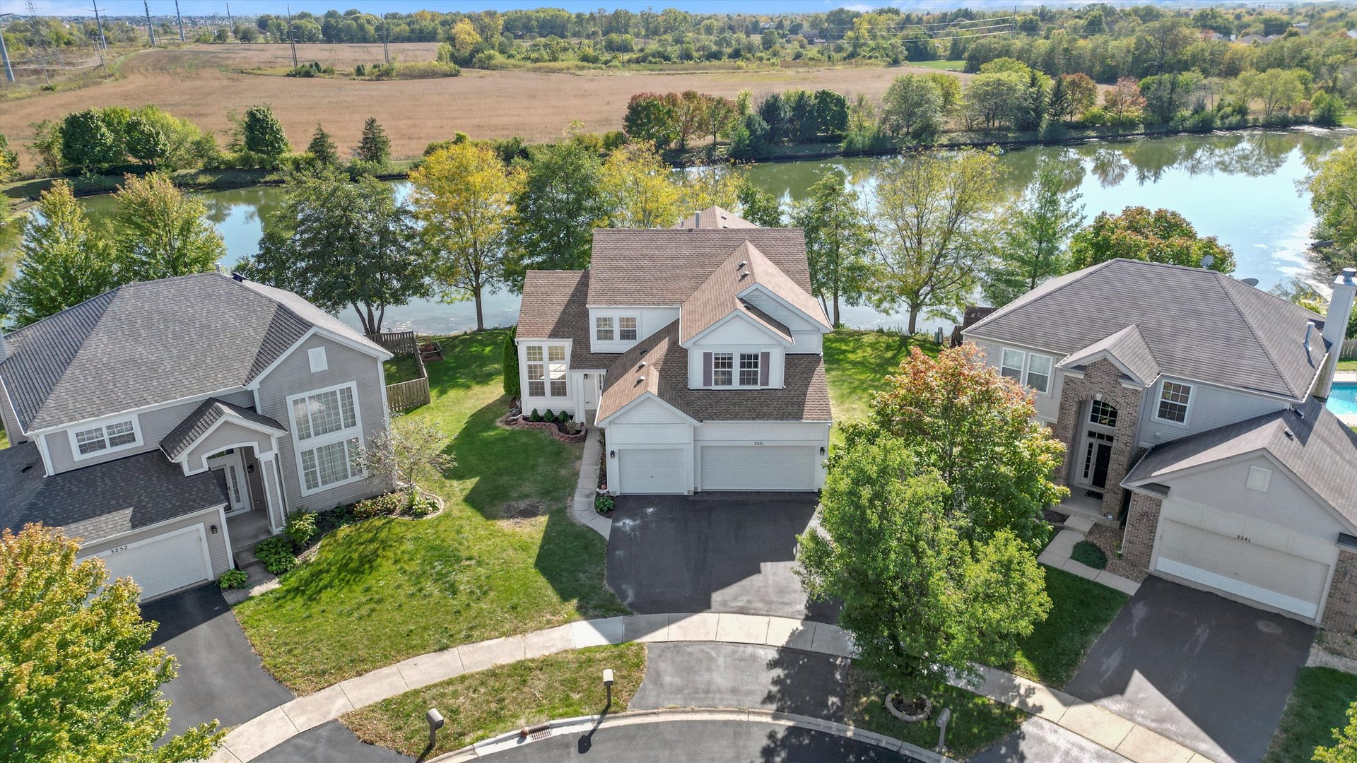 an aerial view of a house with a lake view