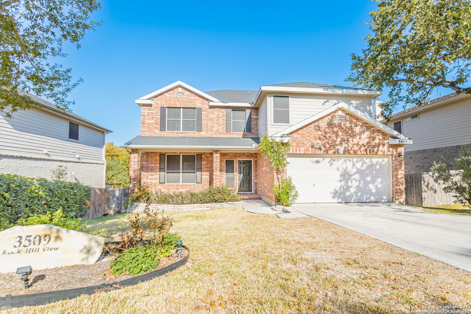 a front view of a house with a yard