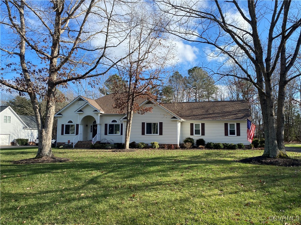 Single story home with a front yard