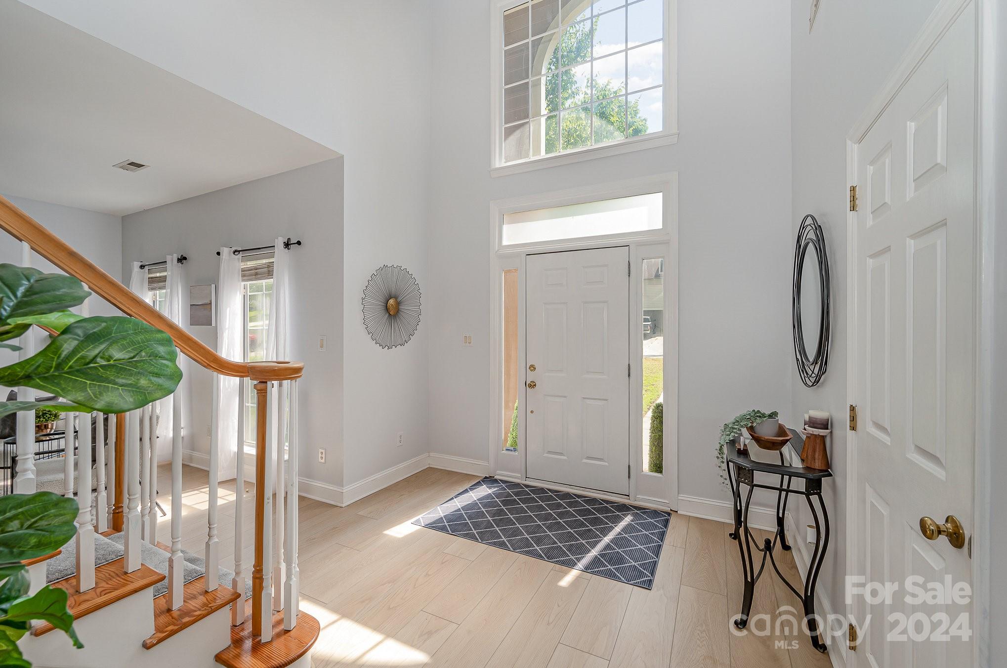 a view of entryway with wooden floor and front door