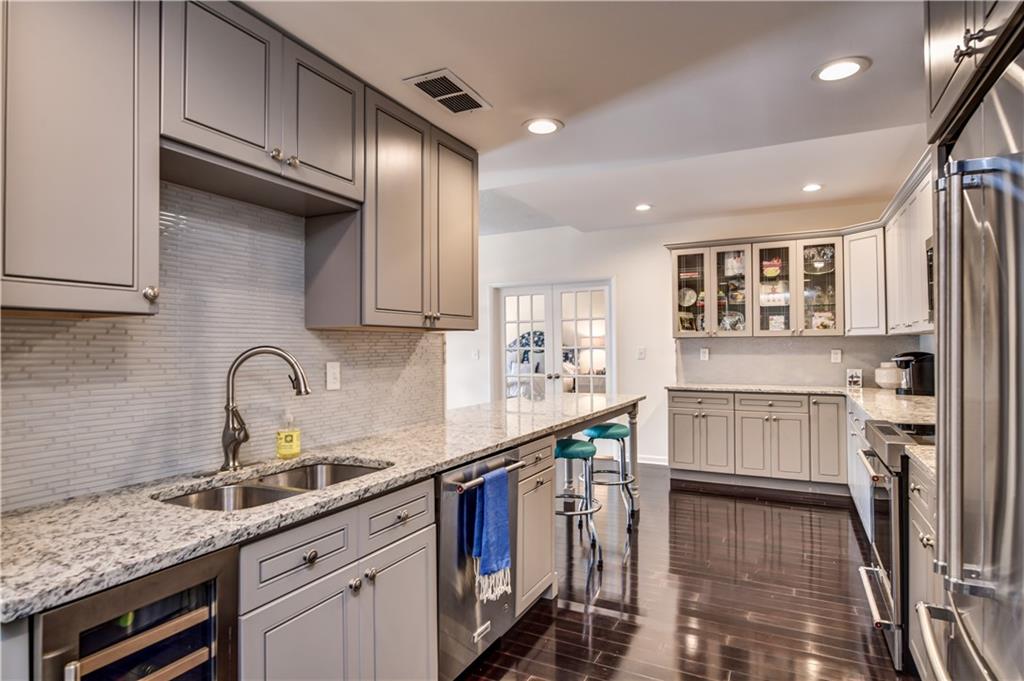 a kitchen with a sink stainless steel appliances and cabinets