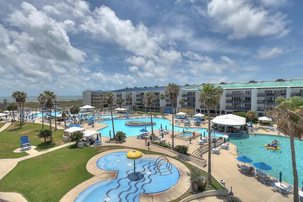 a view of a swimming pool with outdoor seating