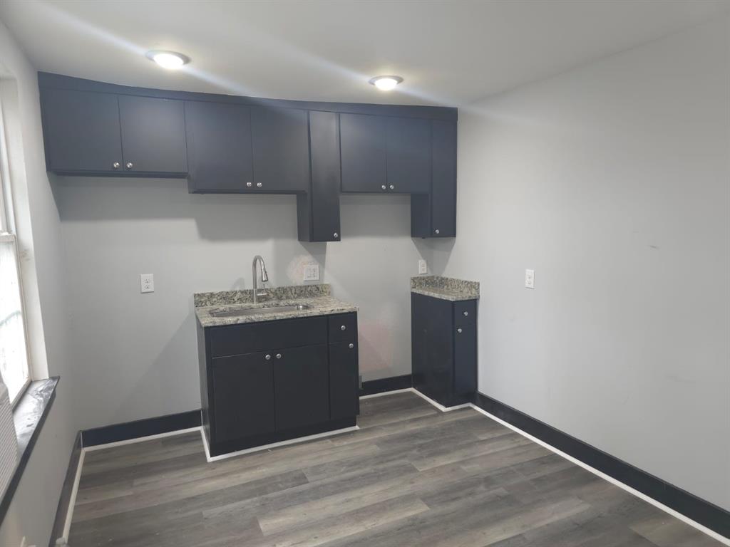 a kitchen with kitchen island sink and refrigerator