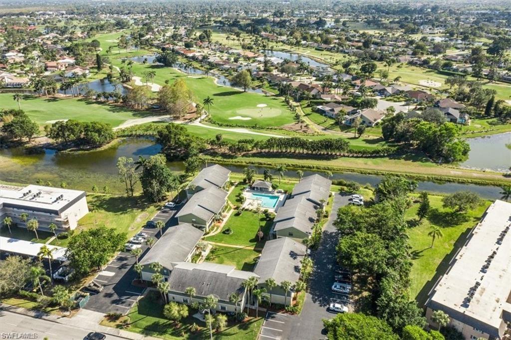 an aerial view of residential houses with outdoor space and lake view