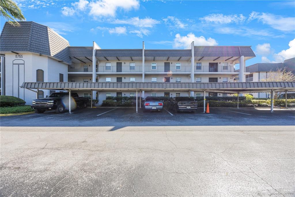 a view of a building with cars parked