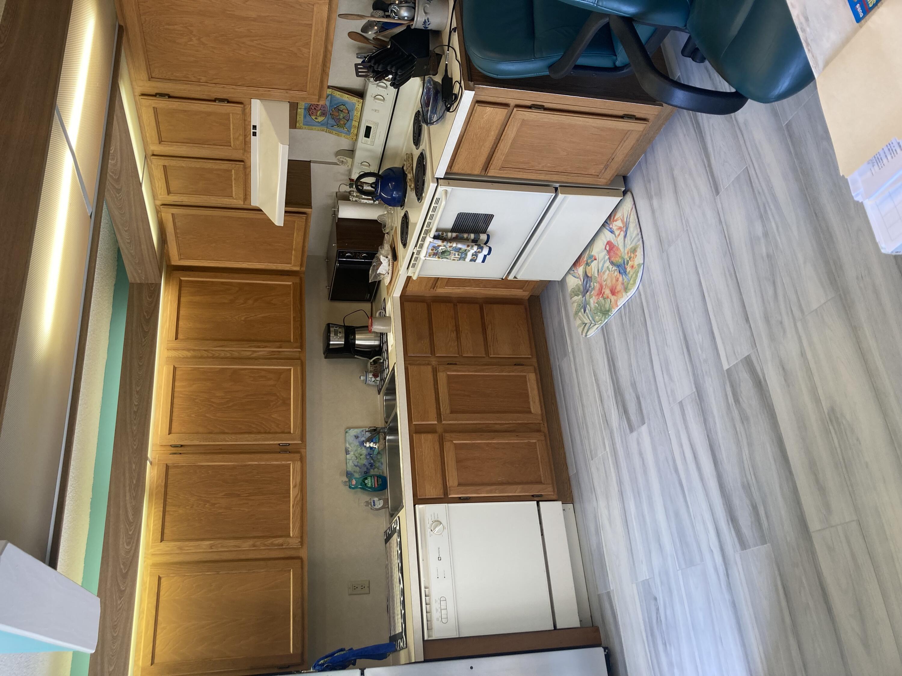 a kitchen with a sink cabinets and white appliances