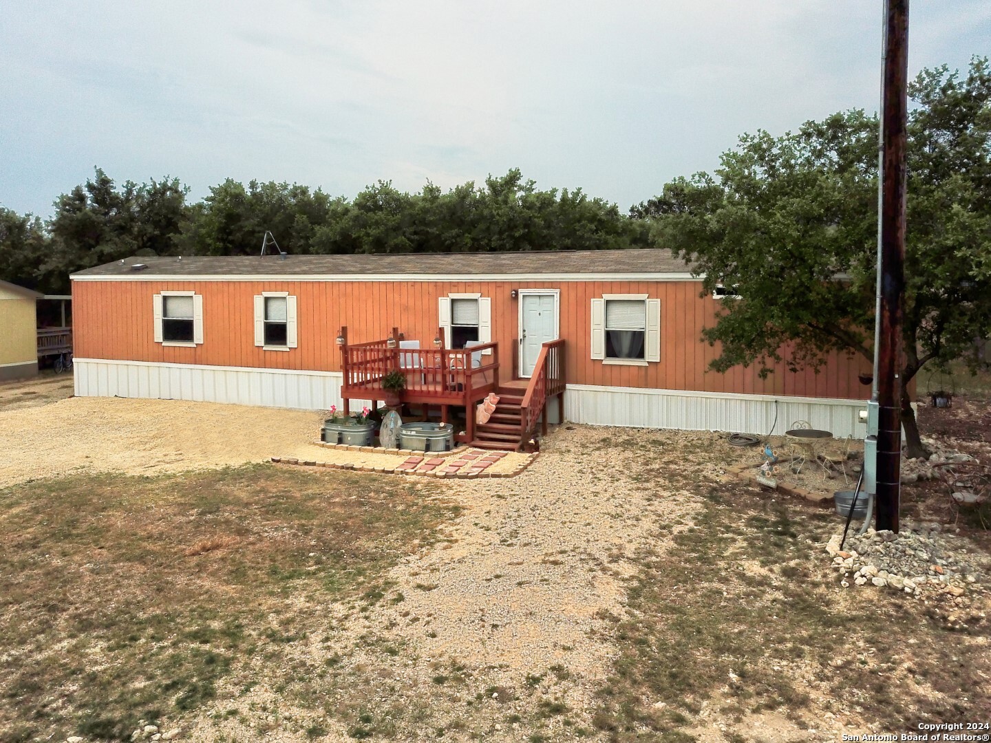 a backyard of a house with table and chairs