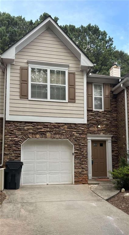 a front view of a house with garage