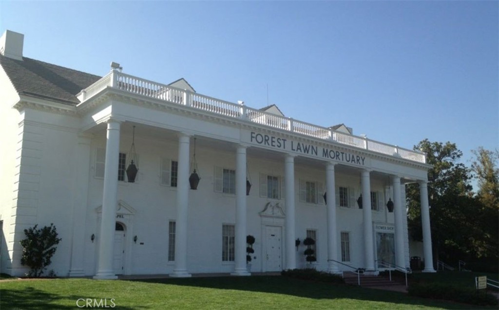 a view of white house with a yard