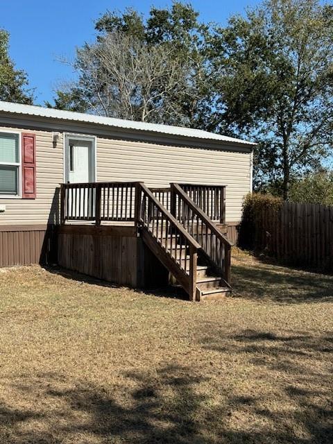 a view of wooden house with a yard