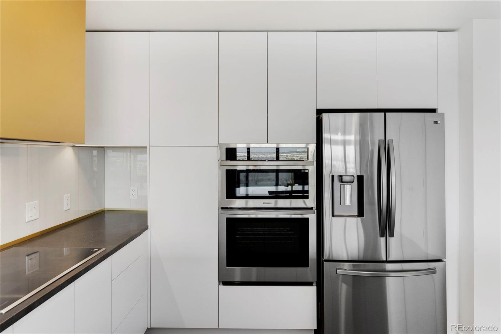 a kitchen with kitchen island a counter top space cabinets and stainless steel appliances