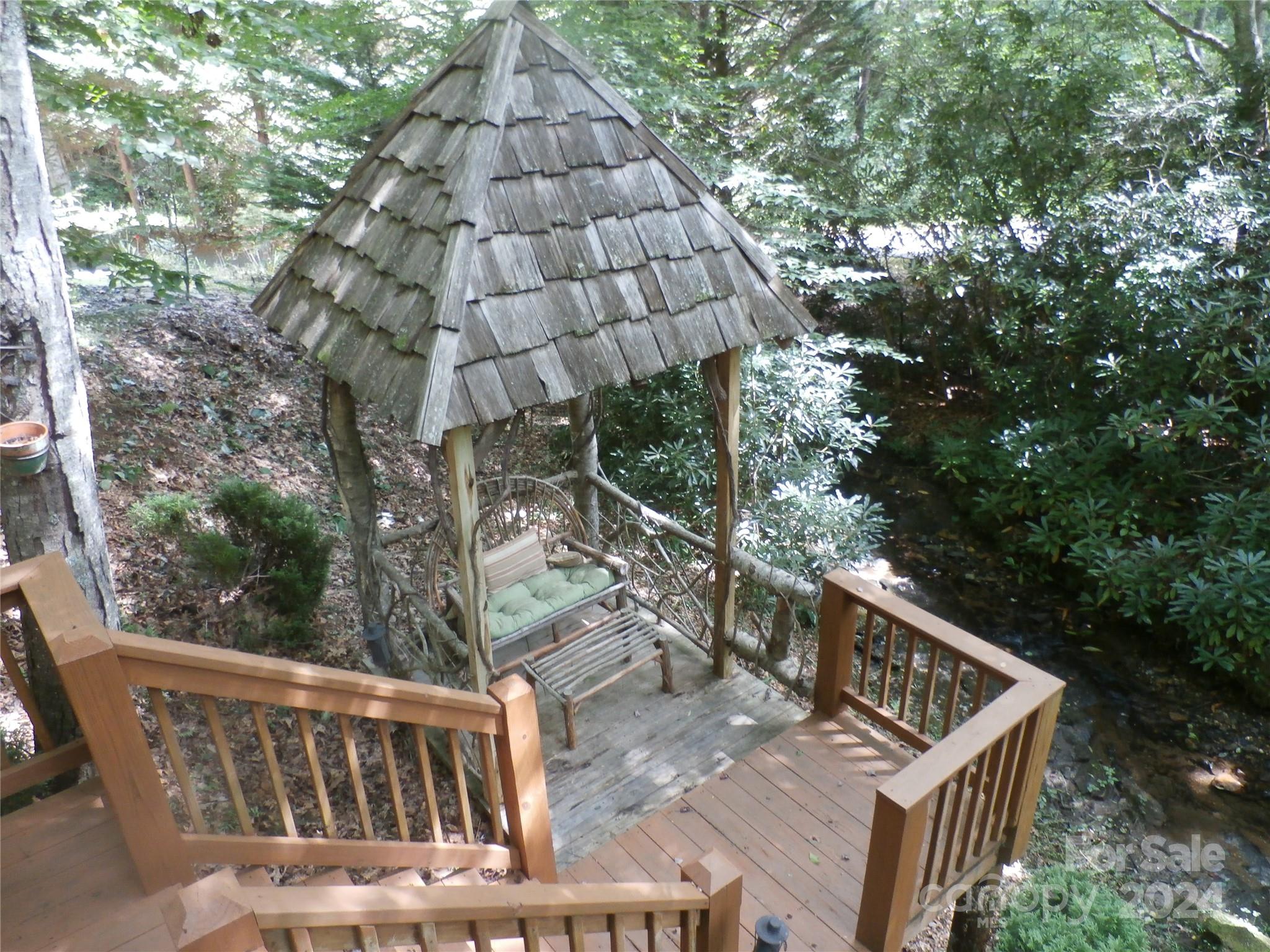 a view of a roof deck with wooden fence and floor