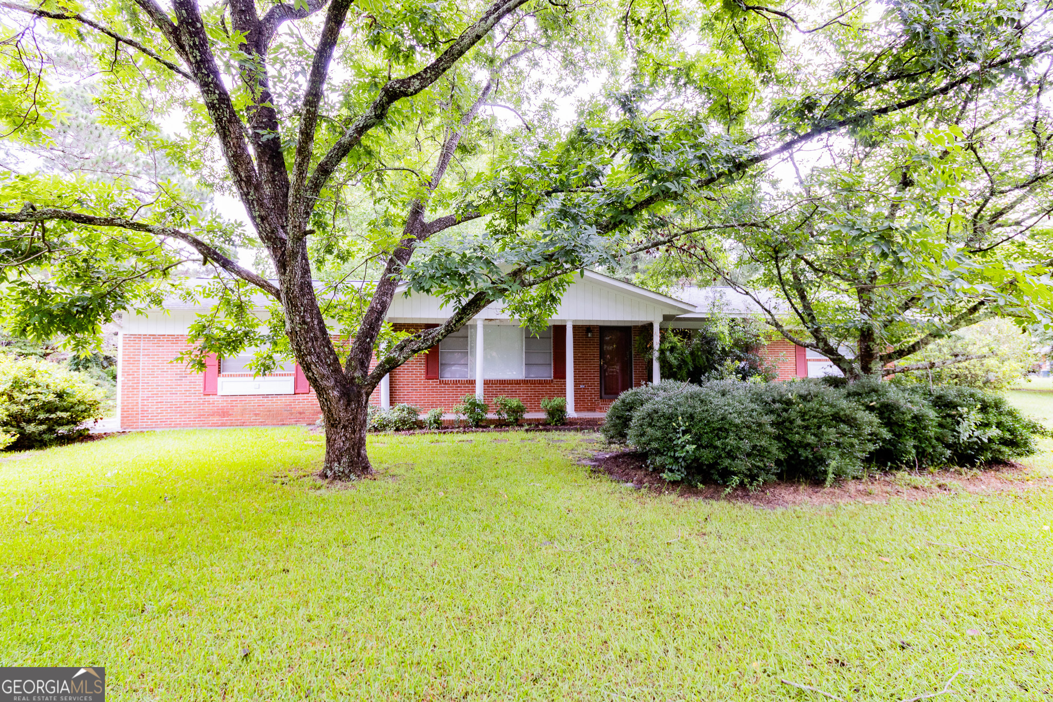 a view of house with yard and entertaining space