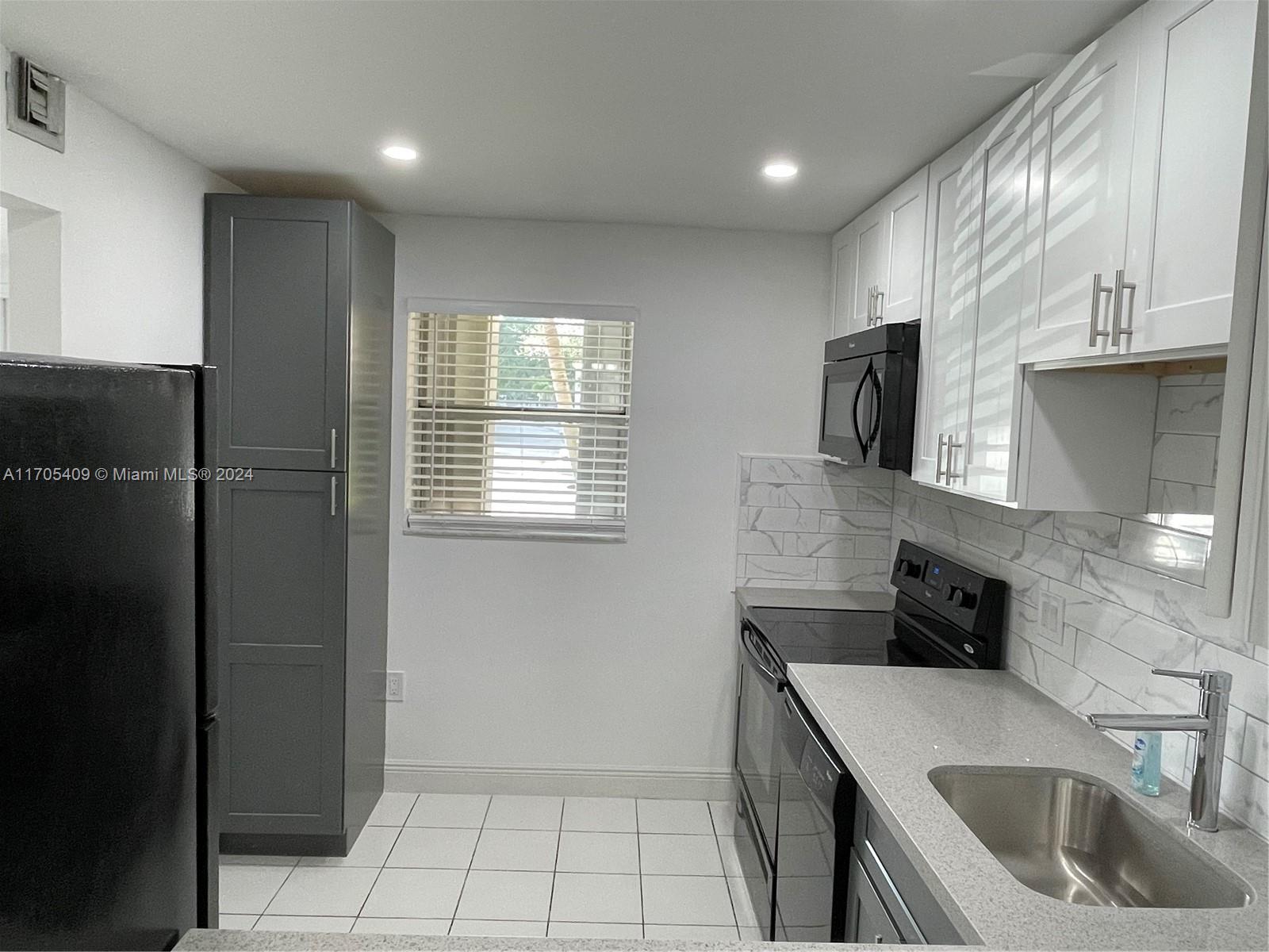 a kitchen with a sink a stove and refrigerator