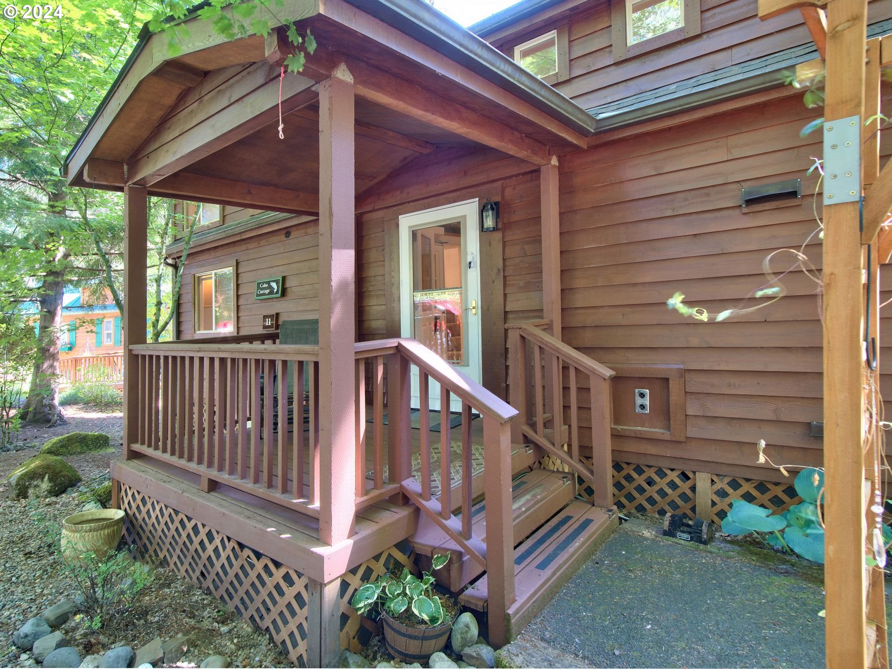 a view of a house with wooden floor and a small yard