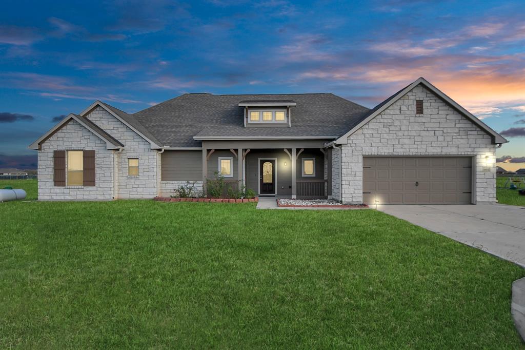 a front view of a house with a yard and garage