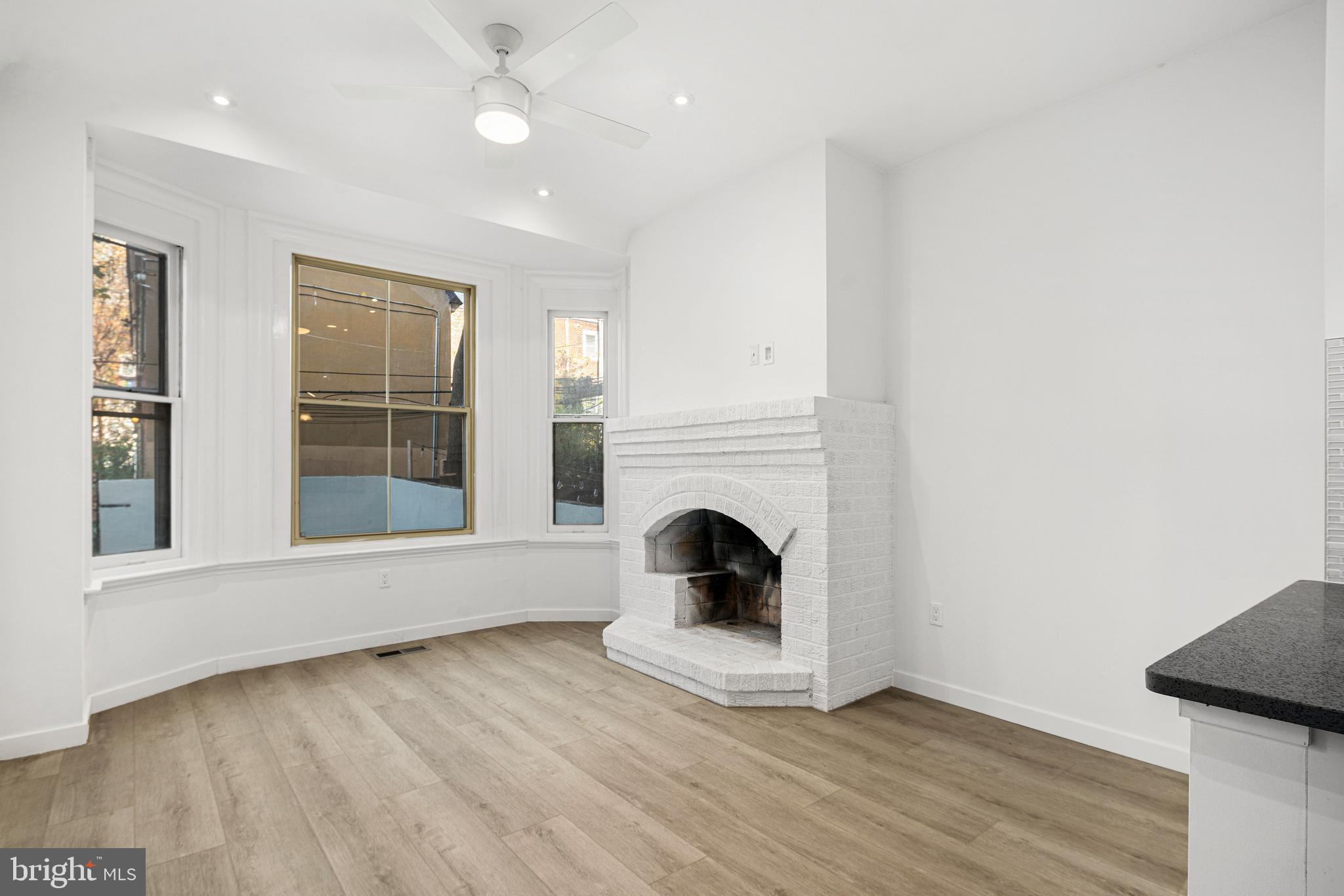 a view of a livingroom with a fireplace and wooden floor