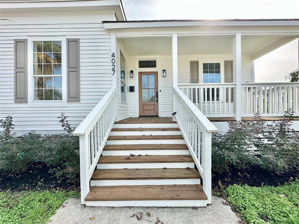 a view of a house with wooden fence