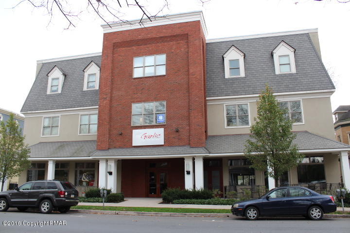 a car parked in front of a brick building