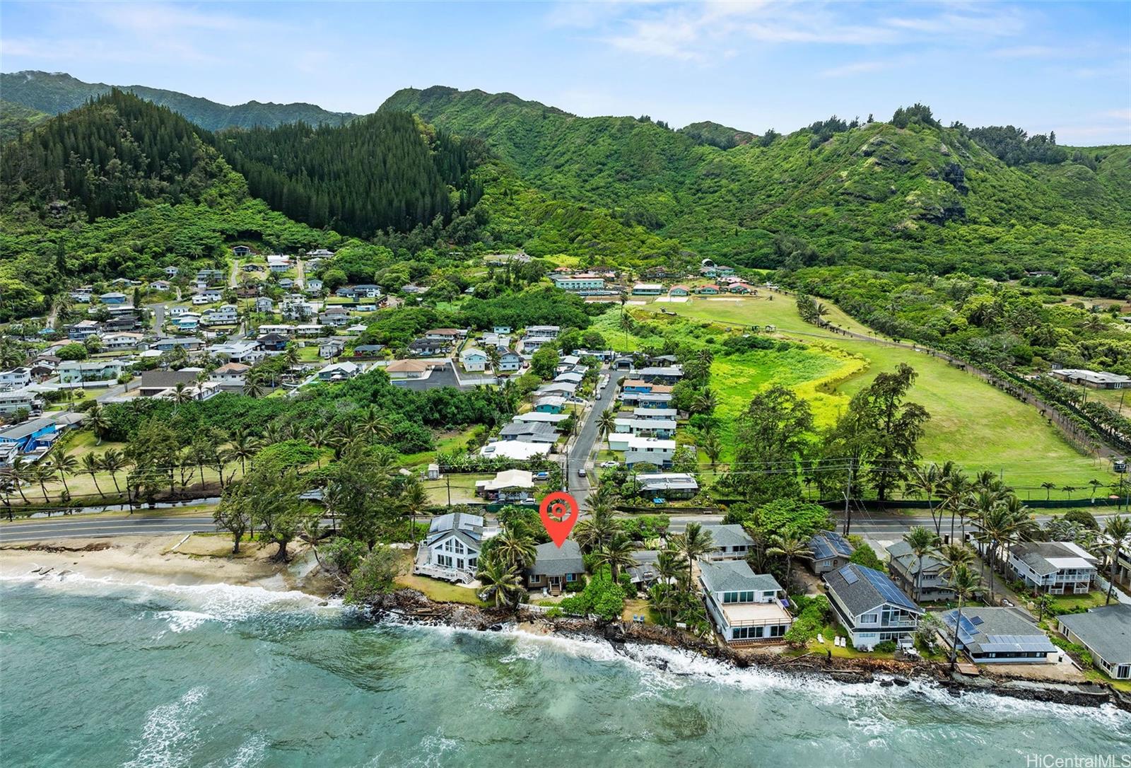 an aerial view of residential houses with outdoor space and trees