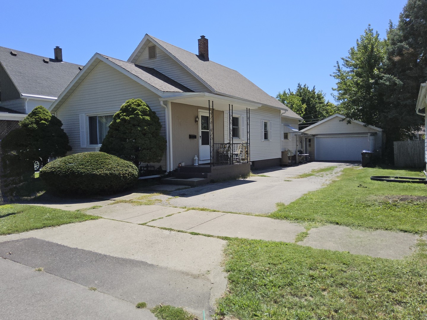 a front view of a house with a yard and potted plants